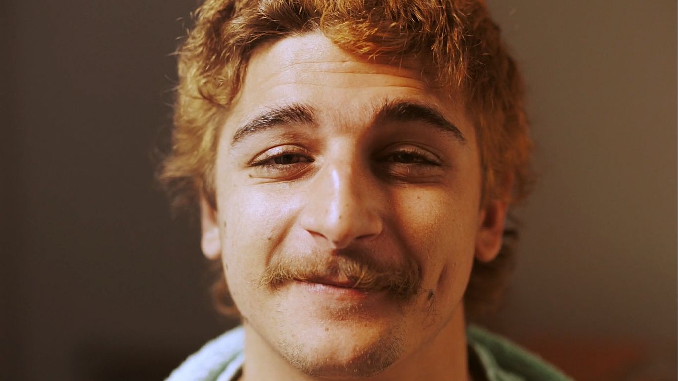 a close up of a person with a moustache