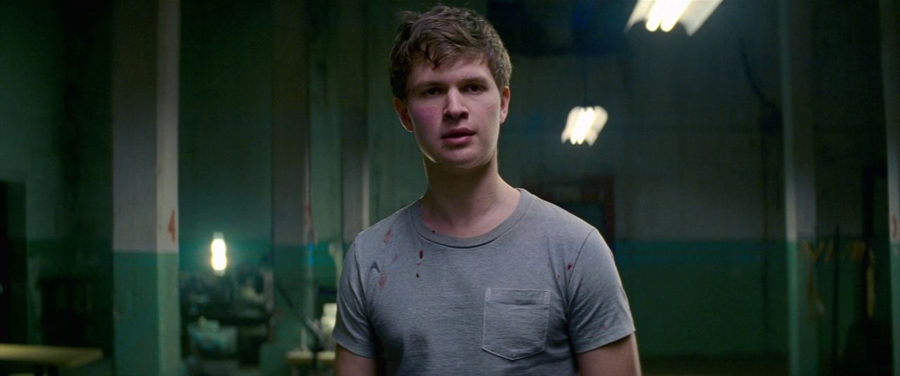 a young man standing in a green room