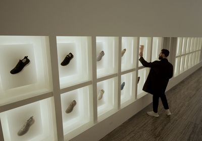 a man standing in front of a display of shoes