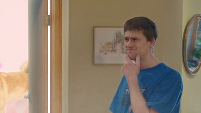 a man brushing his teeth in front of a mirror