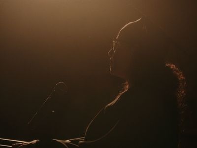 a woman standing in front of a microphone