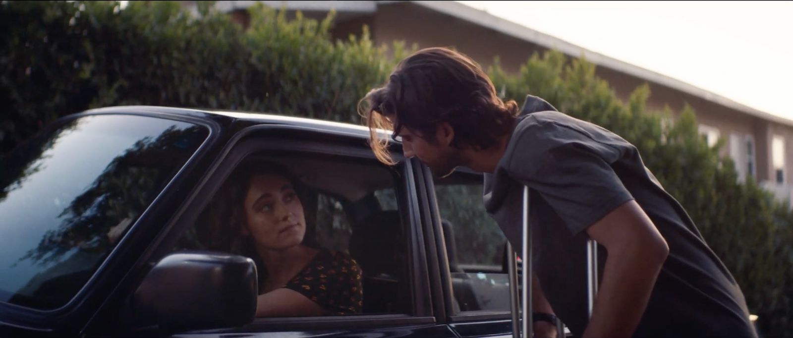 a woman leaning out the window of a car