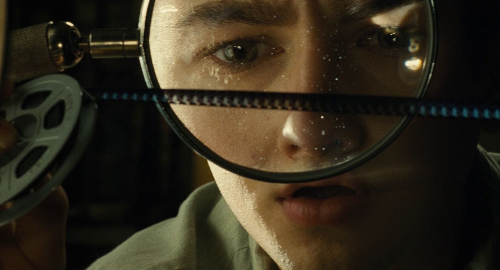 a man looking through a magnifying glass