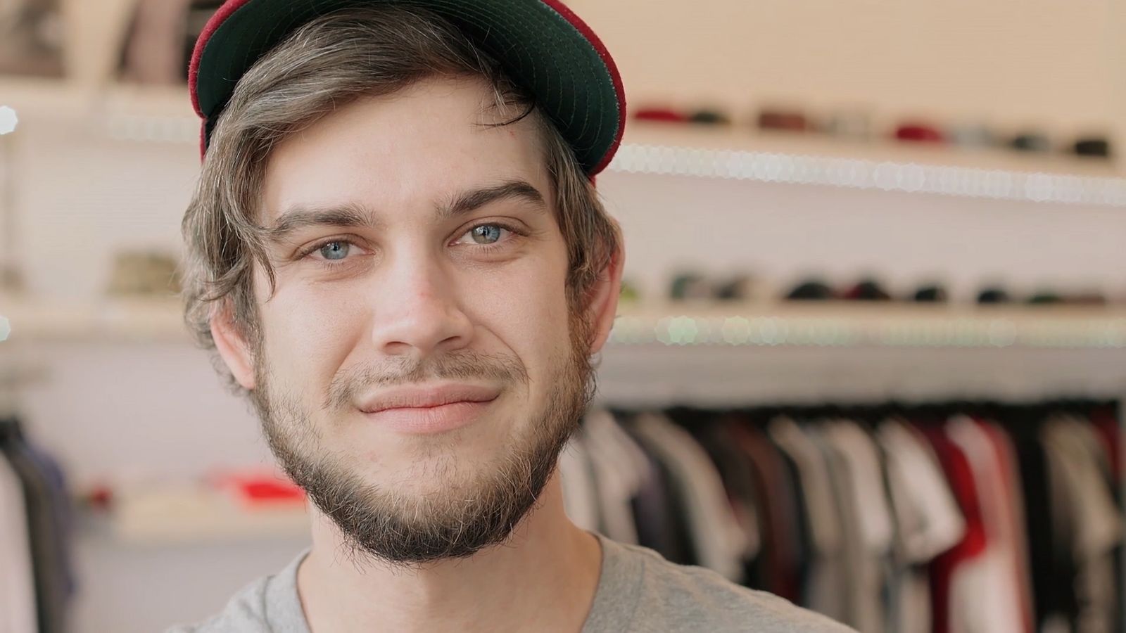 a man with a beard wearing a hat