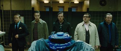 a group of men standing next to each other in a bathroom