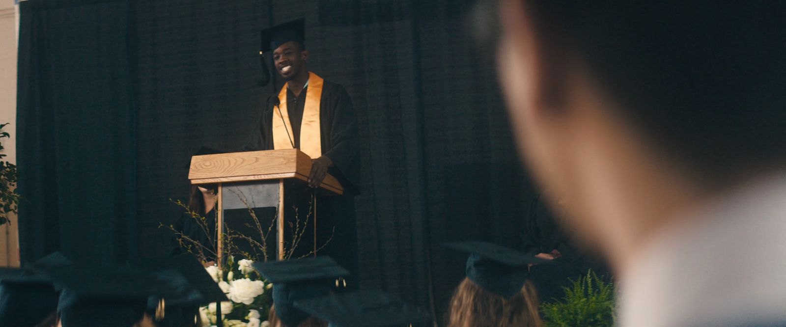 a man standing at a podium in front of a crowd