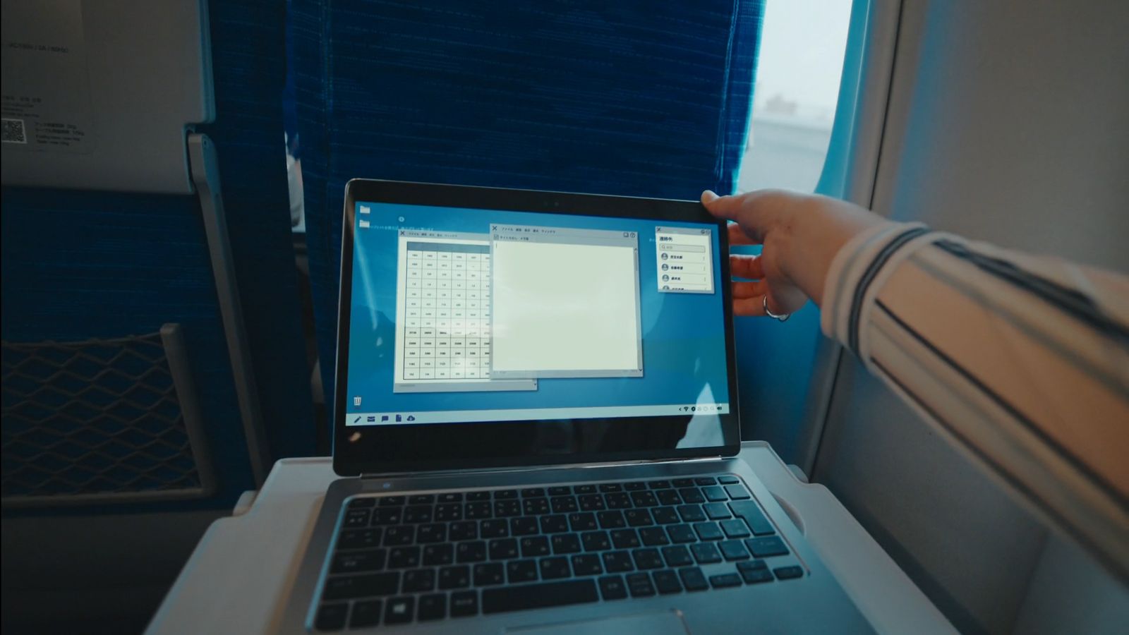 a person holding a laptop computer in their hand