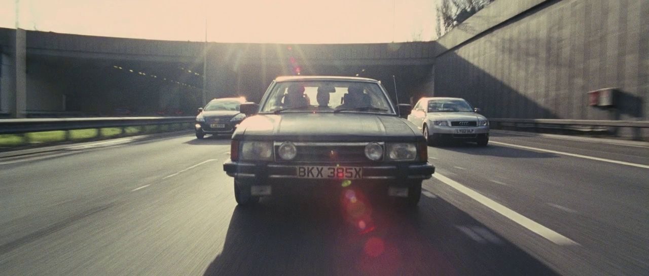 a car driving down a highway next to other cars