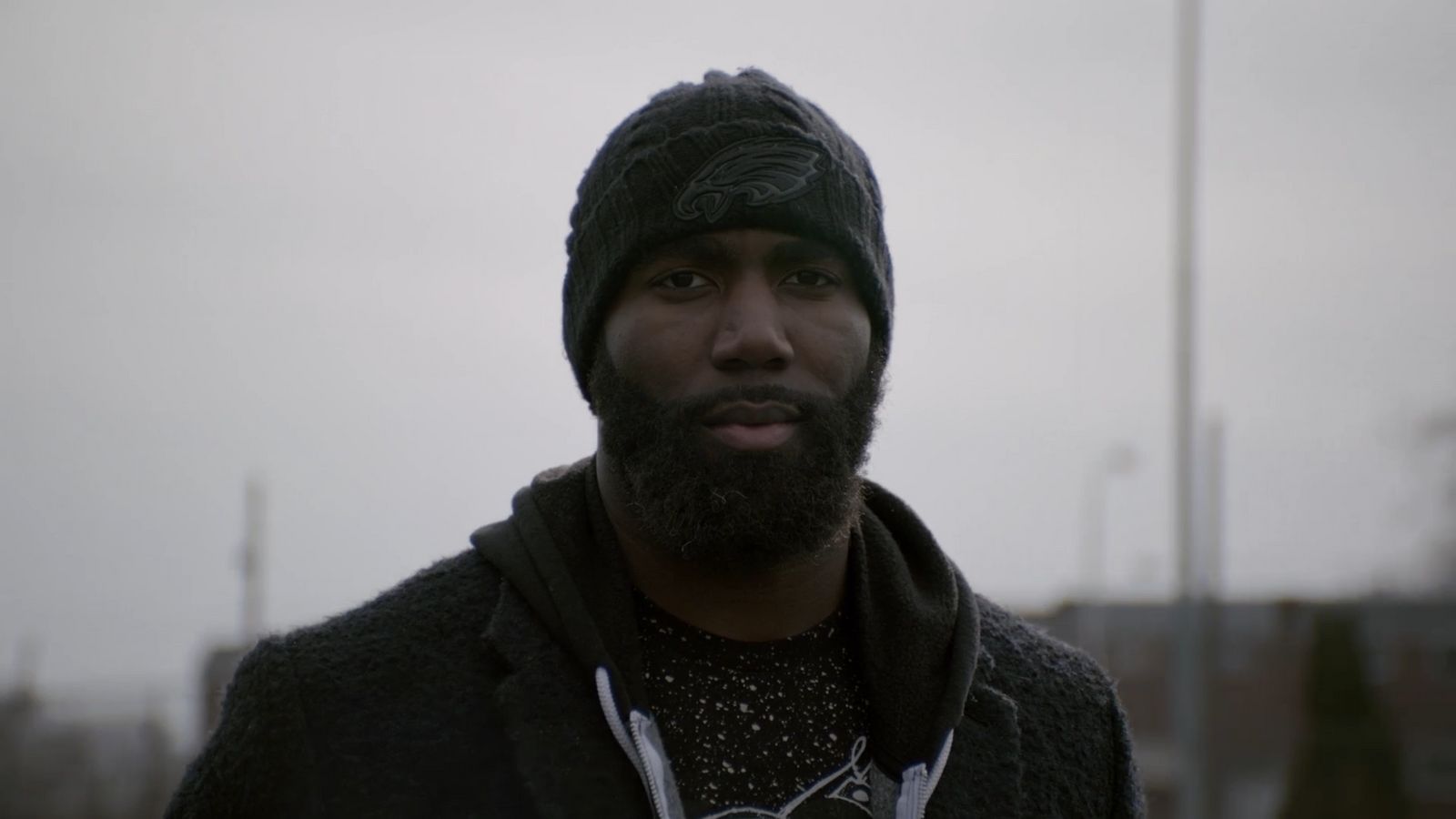 a man with a beard wearing a beanie