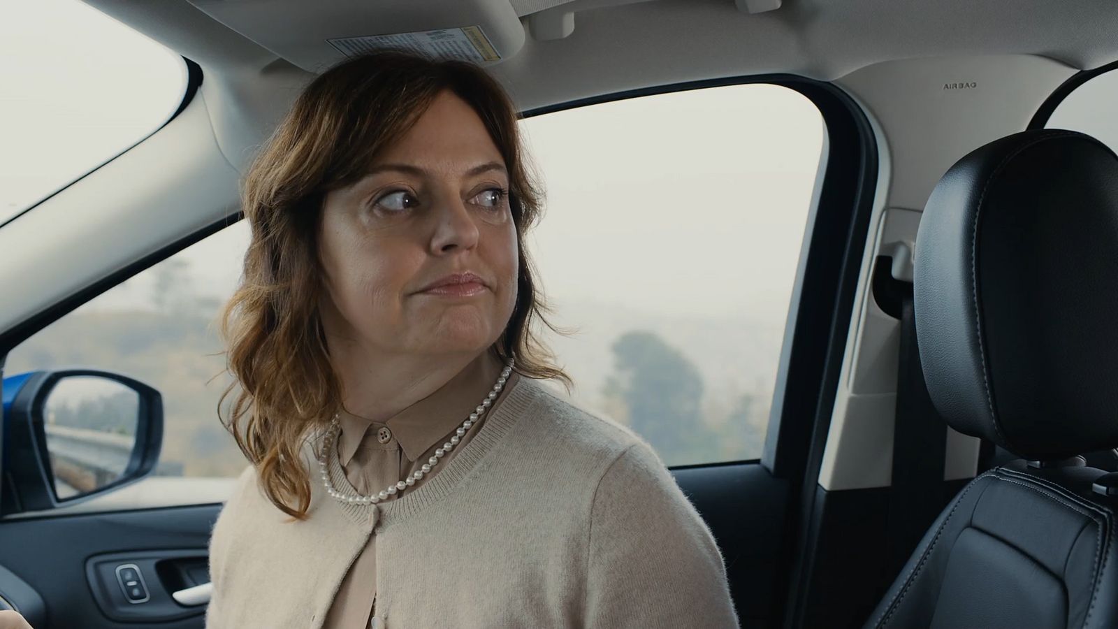 a woman sitting in the back seat of a car