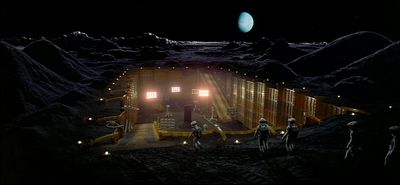 a group of people standing in front of a building on the moon