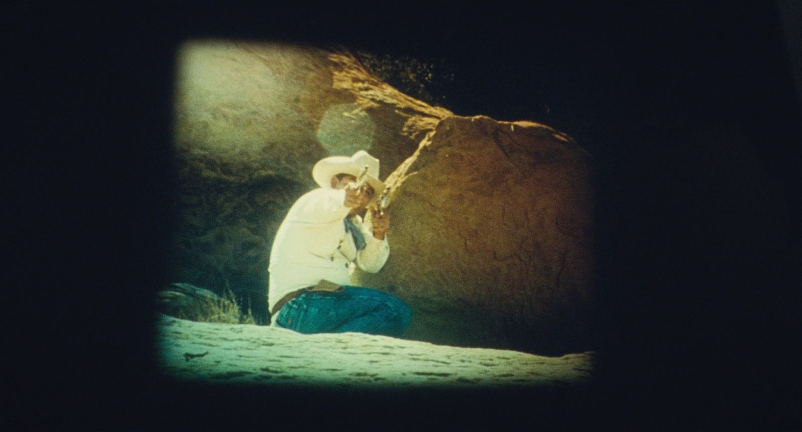 a man sitting on a rock in the dark