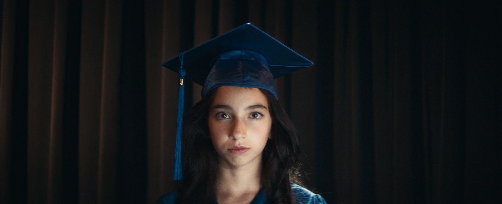 a woman wearing a graduation cap and gown