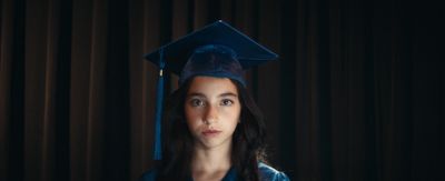 a woman wearing a graduation cap and gown