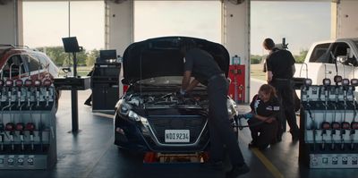 a man working on a car in a garage