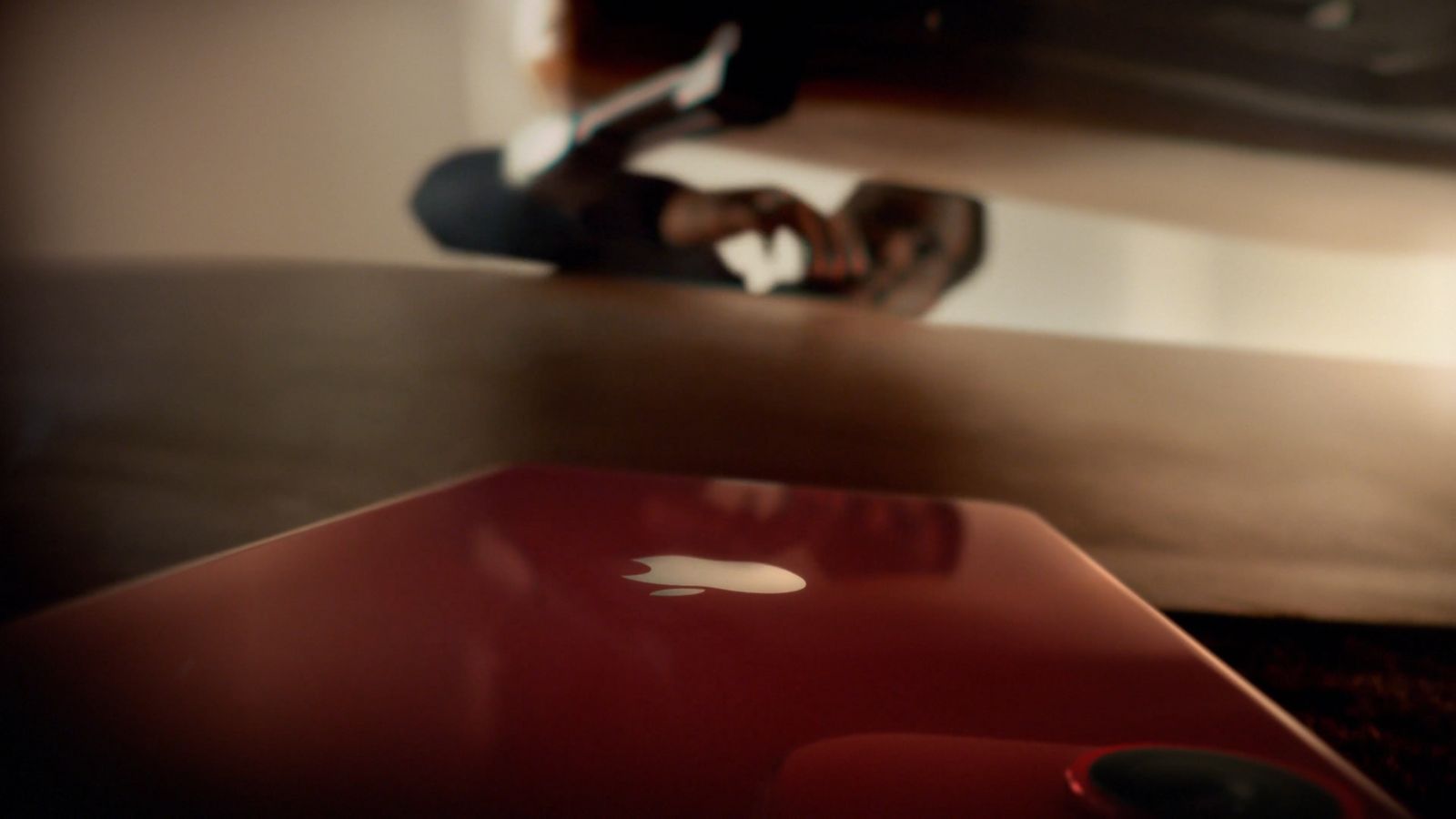 a red apple laptop sitting on top of a wooden table