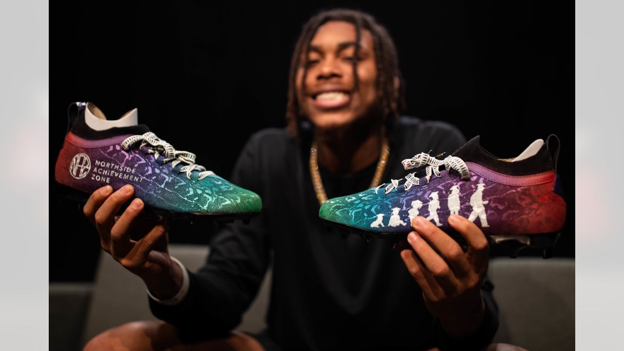 a man sitting on a couch holding a pair of shoes