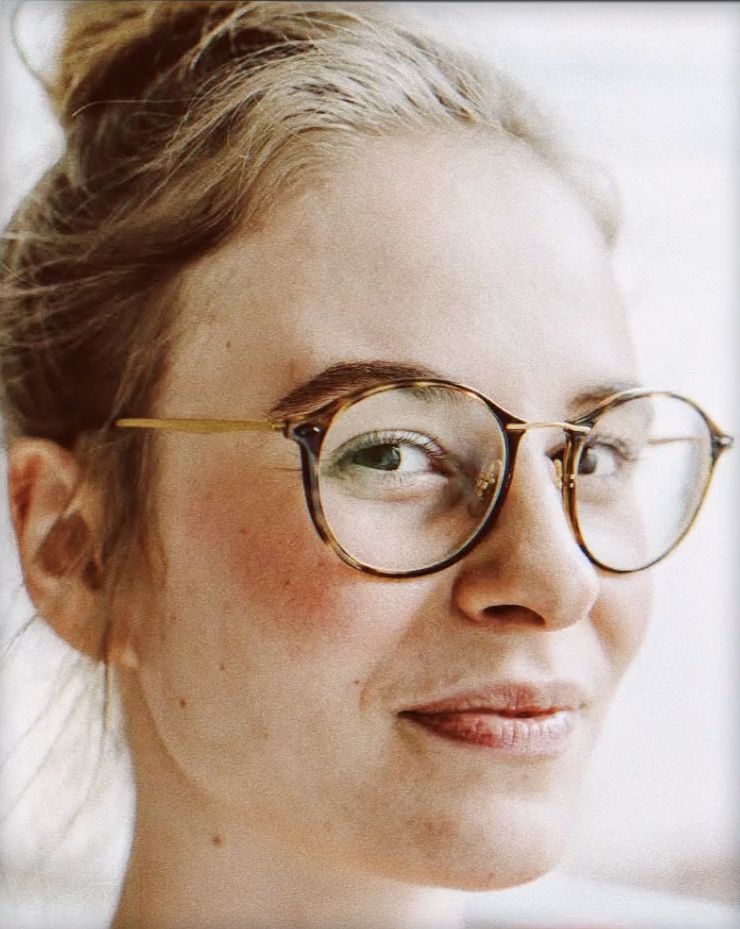 a close up of a person wearing glasses