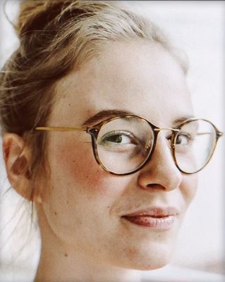 a close up of a person wearing glasses