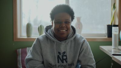 a young person sitting in front of a window