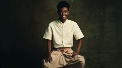 a man in a white shirt and tan pants