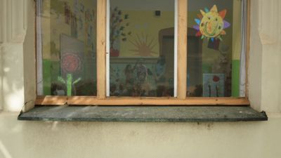 a window with a cat sitting in the window sill