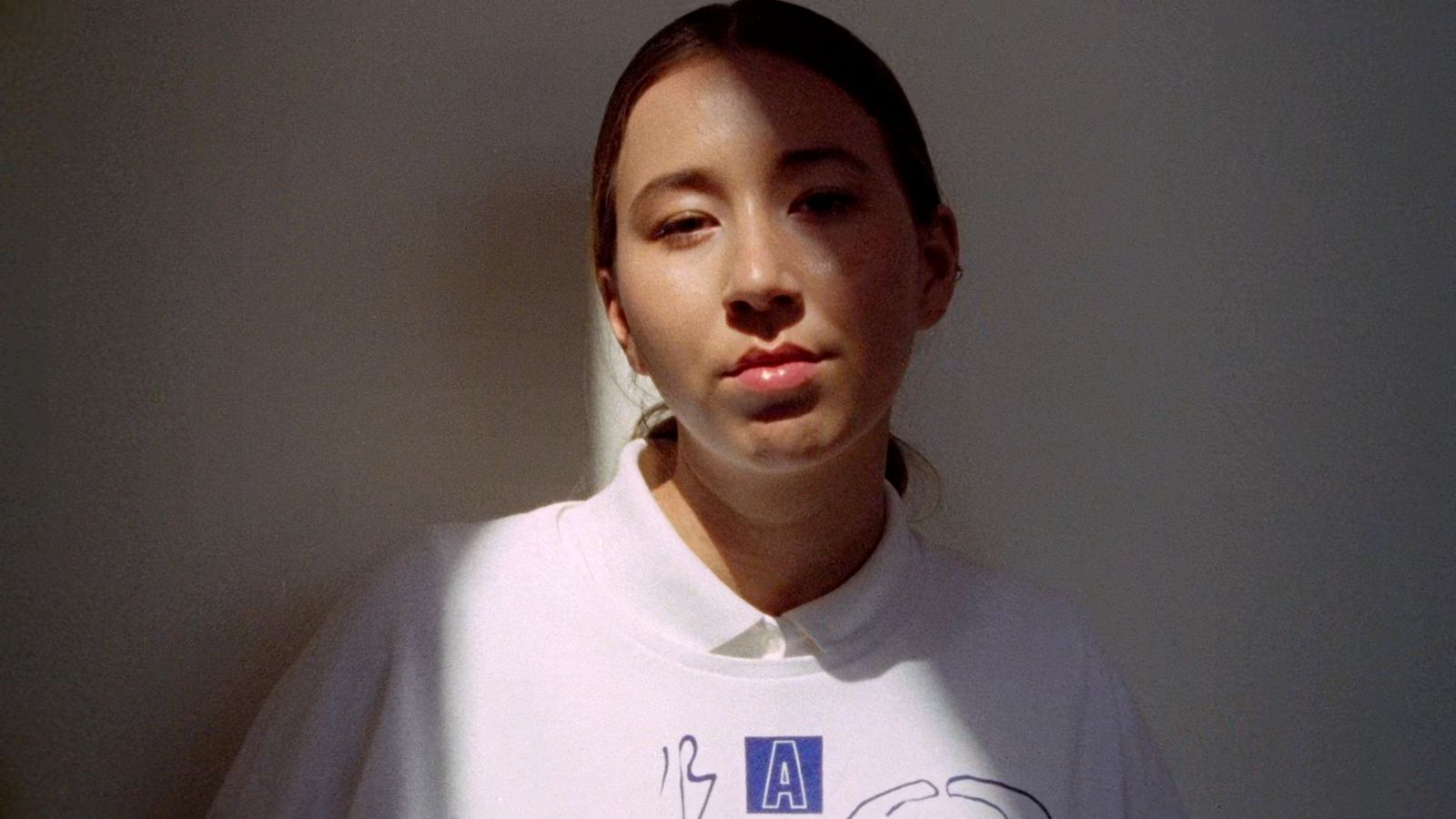 a woman wearing a t - shirt with writing on it