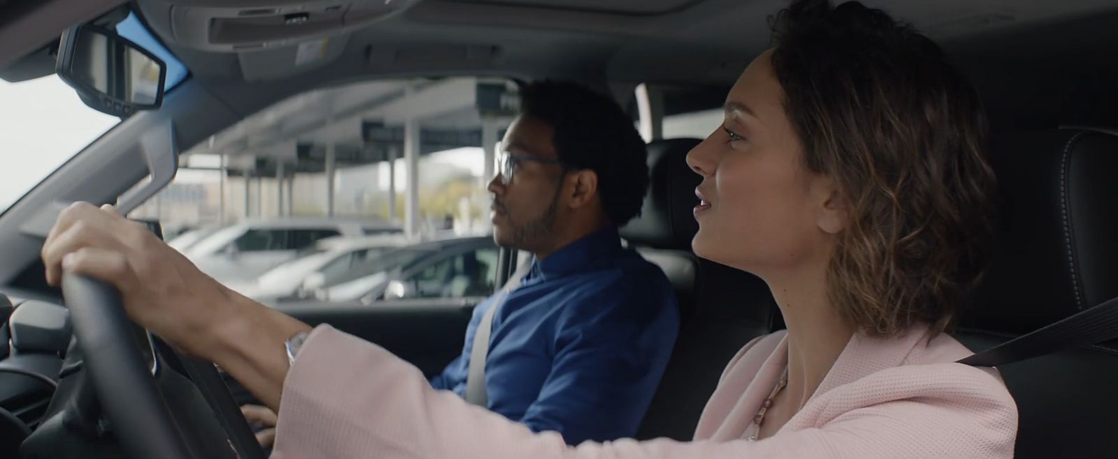 a man and a woman sitting in a car