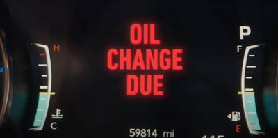 a close up of a speedometer with the words oil change due