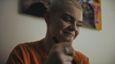 a woman holding a remote control in her hand