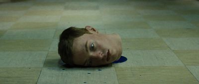 a young man laying on the floor with his head on the floor