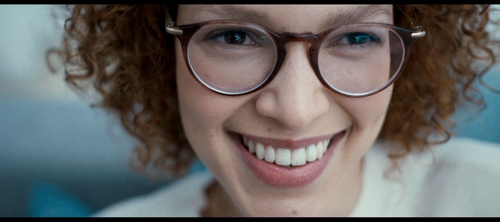 a close up of a person wearing glasses