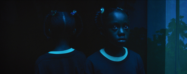 a couple of young girls standing next to each other