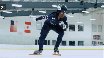 a man riding a skateboard on top of an ice rink