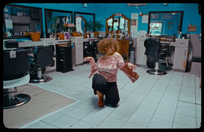 a woman in a hair salon is dancing