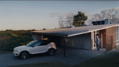 a white car parked in front of a garage