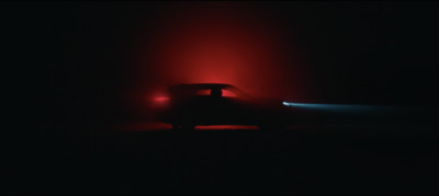 a car in the dark with a red light