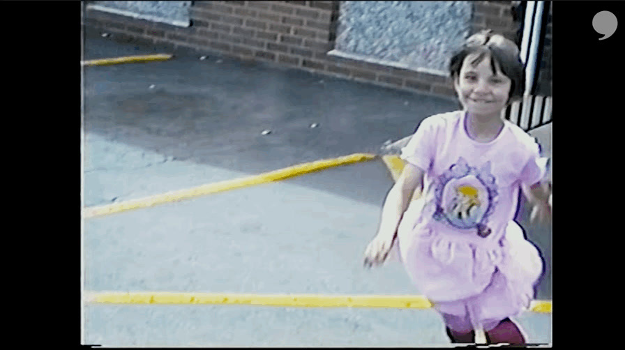 a little girl in a purple dress is playing with a frisbee