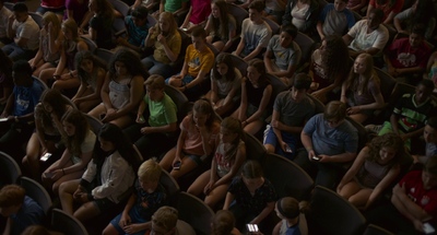 a large group of people sitting in a room