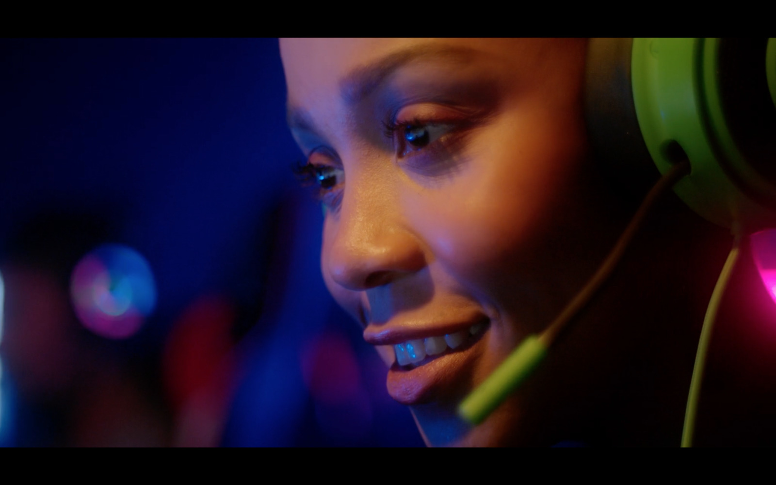 a woman wearing headphones and smiling at the camera