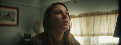 a woman standing in front of a window in a room