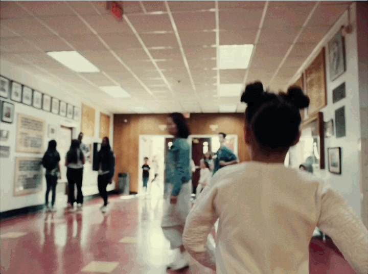 a group of people walking down a hallway