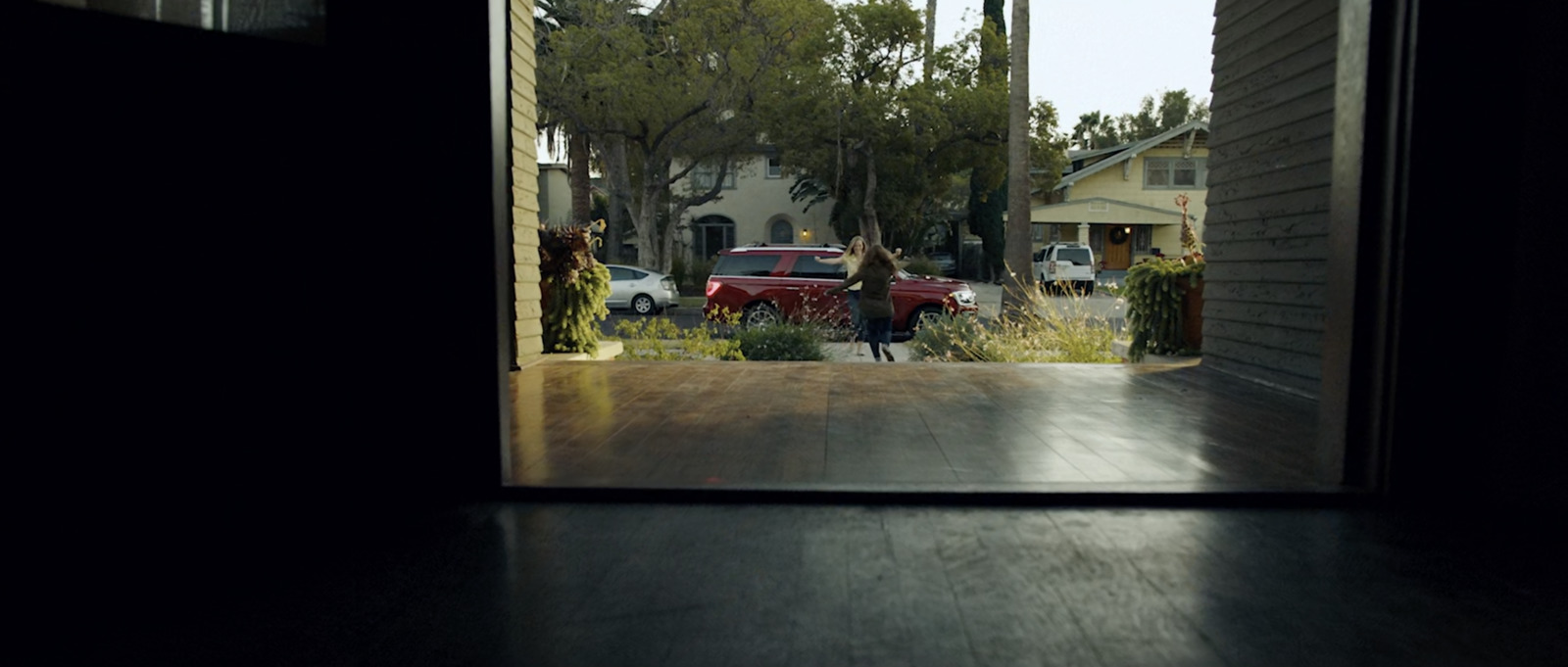 a person walking out of a doorway into a house