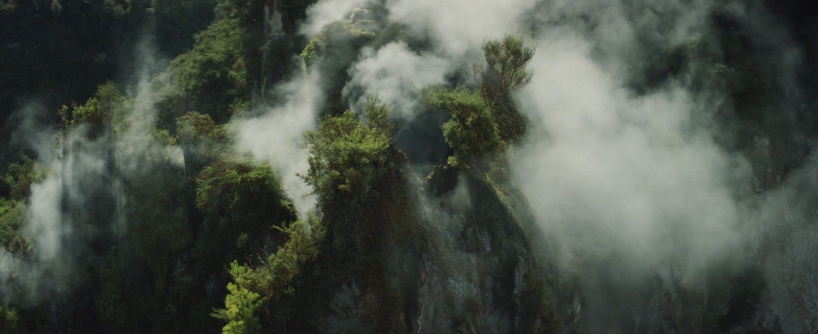 an aerial view of a mountain covered in mist