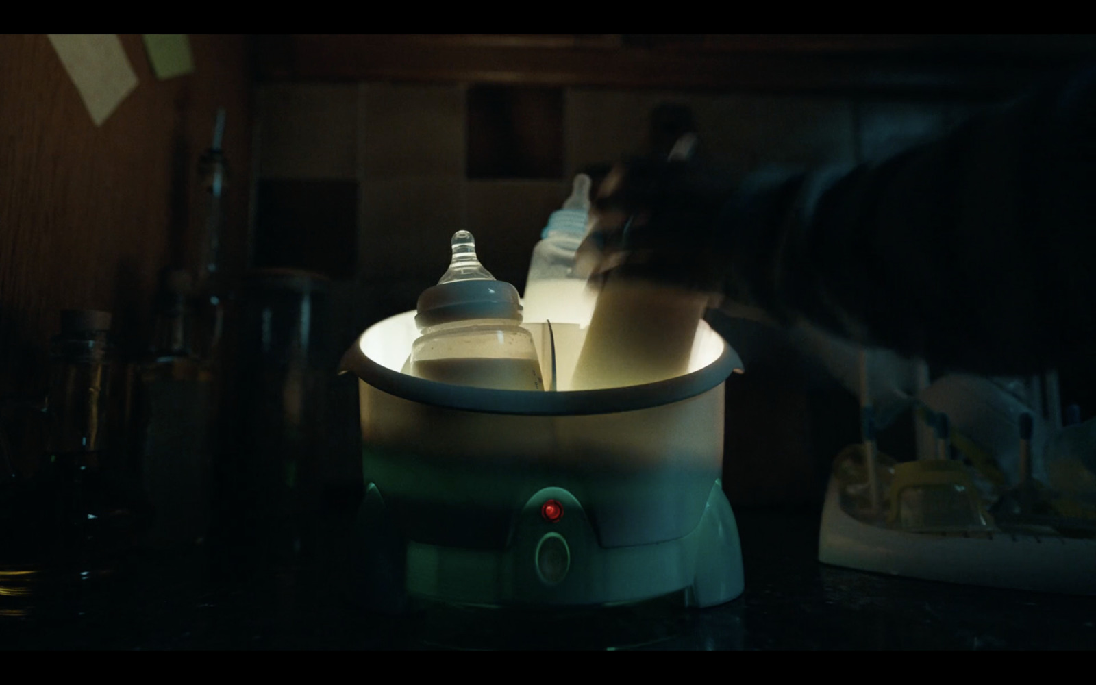 a blender sitting on top of a counter next to bottles