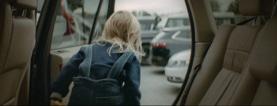 a woman walking out of a car with her back to the camera