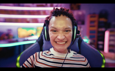 a woman wearing headphones and smiling for the camera