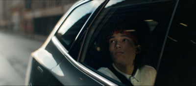 a woman sitting in a car looking out the window