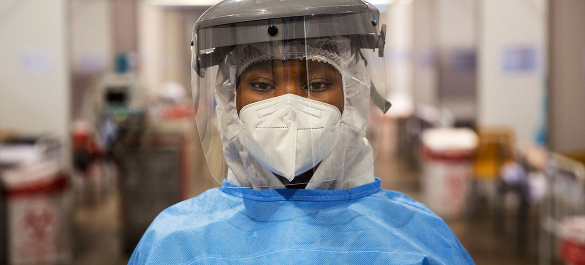 a person wearing a protective mask and a face shield