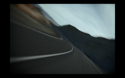 a blurry photo of a mountain road